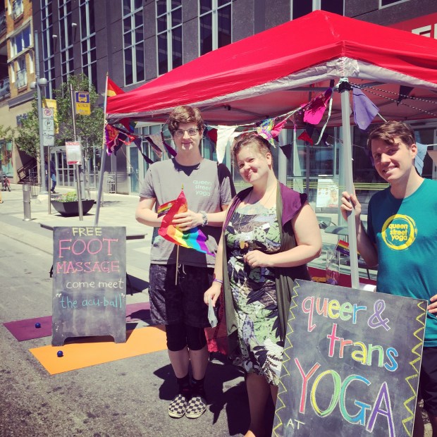 QSY community members promoting Queer & Trans Yoga at this year’s Tri-Pride celebration in front of Kitchener City Hall! Photo Credit: @topherjohnb